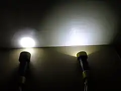 Beam angle comparison between two dive lights with the same LED; with lens on left and without lens on right